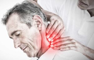 A chiropractor gently adjusting an adult client's upper back in a quiet wellness clinic setting.