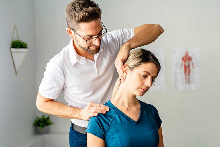 Athlete performing a warm-up beside a clinician reviewing hip and shoulder mobility.